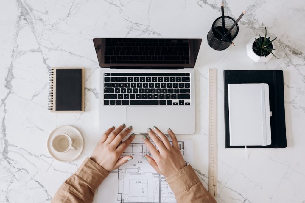 Remote work setup with paper blueprint and laptop symbolizing structured freelance career path