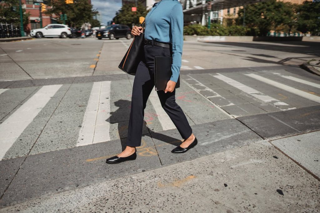 Woman walking on a crosswalk symbolizing the start of a freelance journey