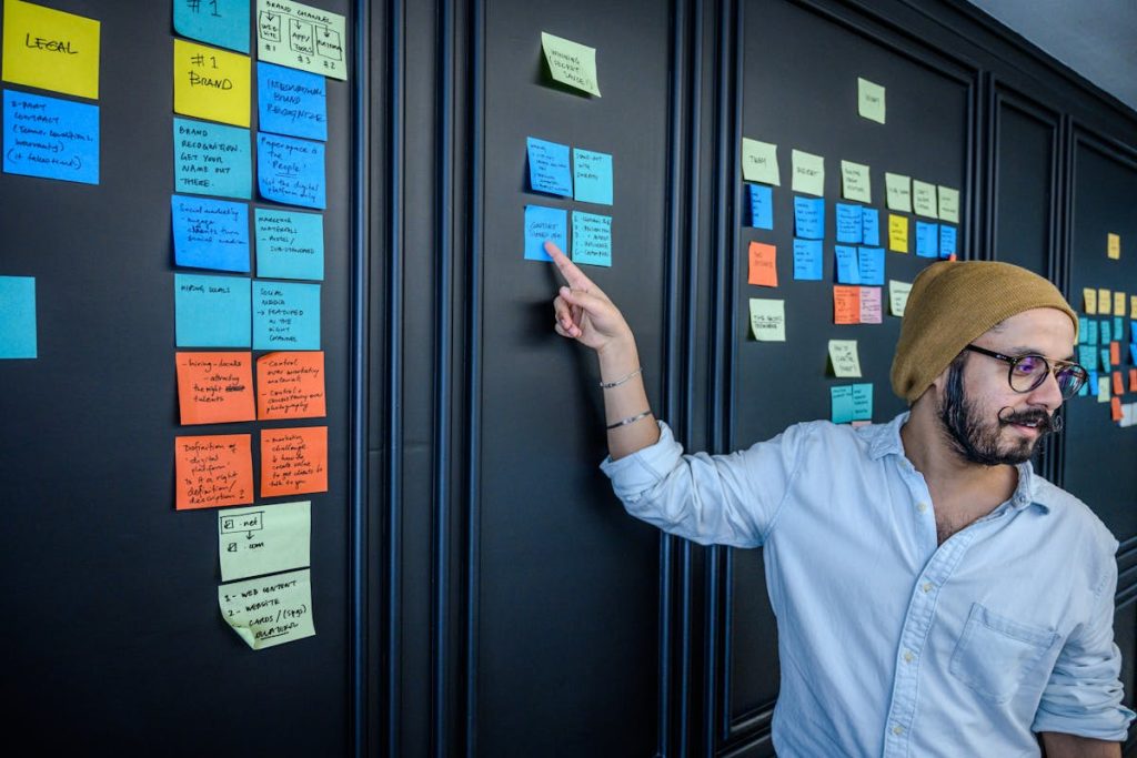 Person choosing from multiple niche ideas on sticky notes, symbolizing strategic decision-making for profit in 2025