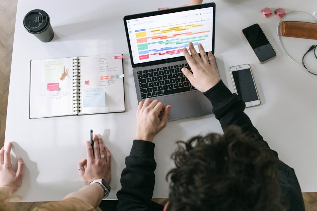 Person using MacBook Pro with diagram on screen, symbolizing a 45-minute daily information-packing method used by non-writers to grow online businesses.