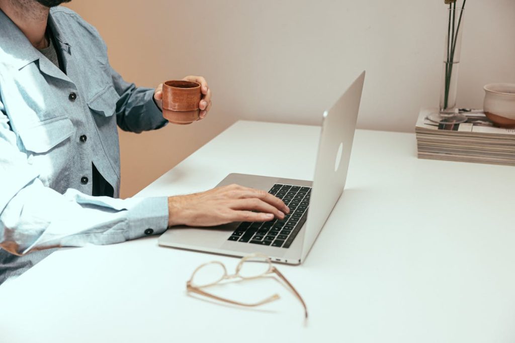 Minimalist workspace with laptop and coffee, illustrating the Weekend Website Formula that generates passive income