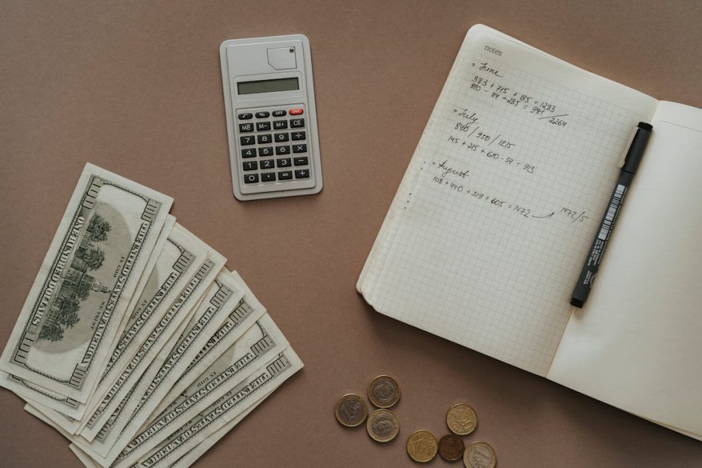 Top-down shot of notebook and cash, illustrating strategic planning for earning $1,750 a month passively