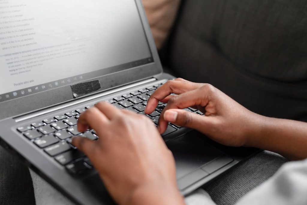 Person typing on his laptop