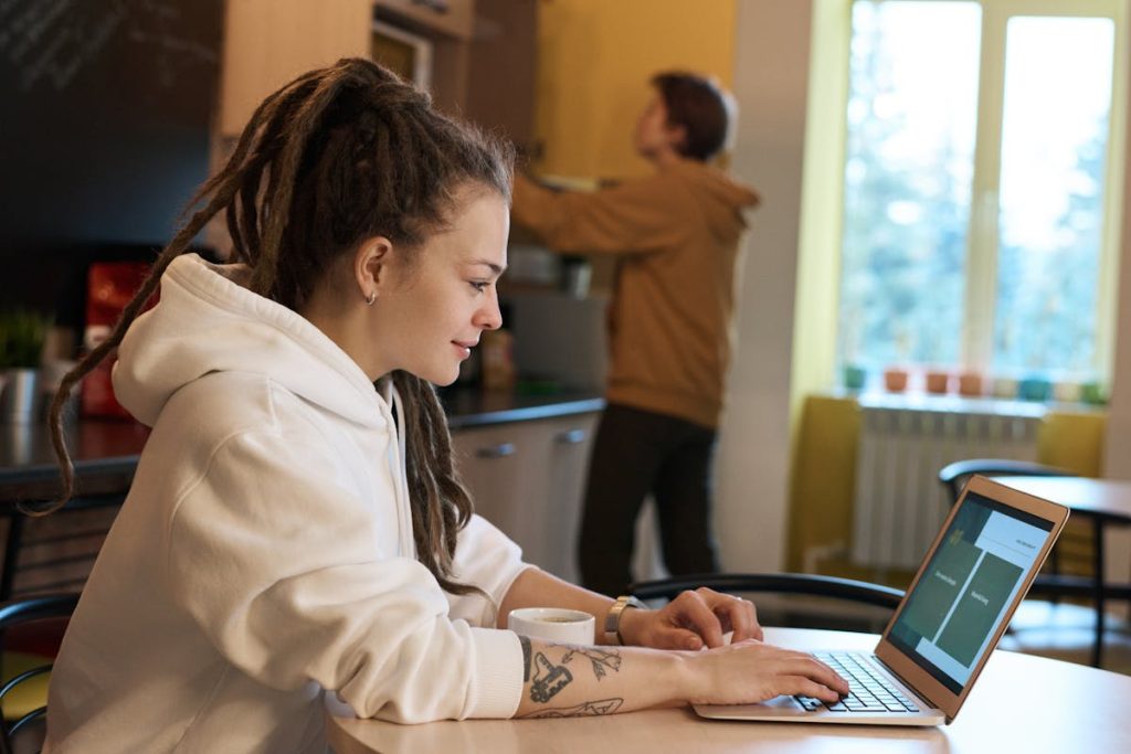 Woman working remotely on a laptop, highlighting effortless chores that make daily income possible