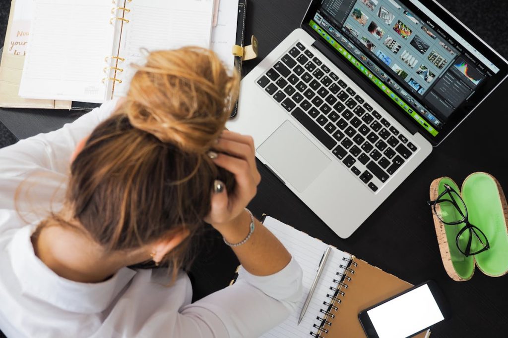 Woman sitting in front of MacBook starting digital decluttering side hustle
