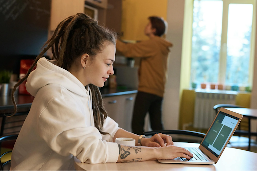a woman in front of her laptop in a coworking space