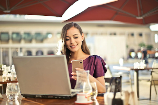a woman texting on her phone in a restaurant