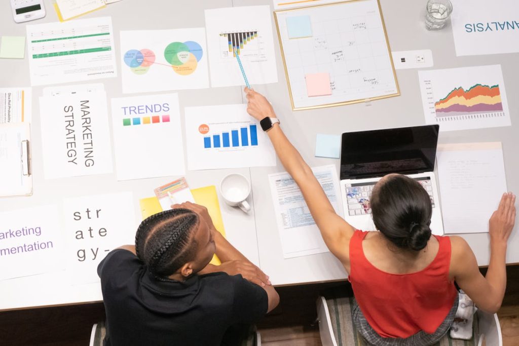 Focused woman pointing at a business graph, symbolizing putting the Invisible Funnel plan into motion