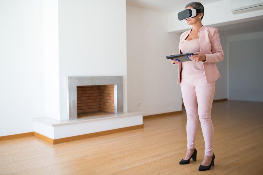 Woman wearing a VR headset in an empty room, symbolizing exploration of virtual properties in the digital real estate space