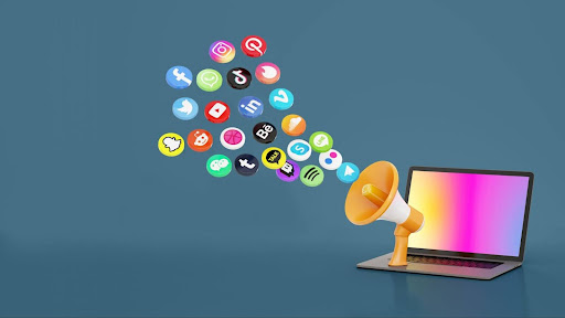 A laptop and megaphone on a blue background, symbolizing social media marketing and digital communication strategies.