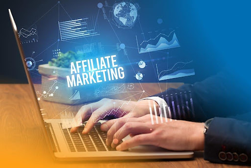 An affiliate marketer typing on his laptop with a suit on.