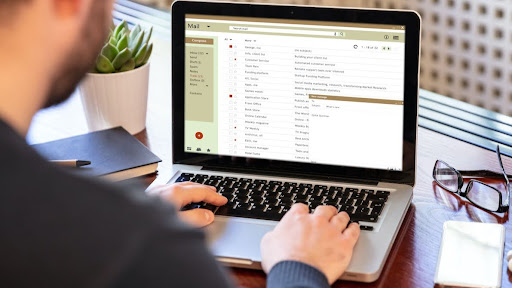 A person creating a broad email list with his laptop while also sending bulk mails