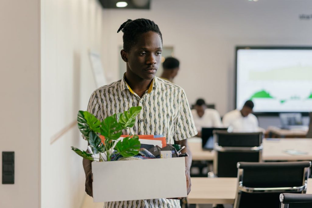 Man carrying a box after quitting his job, representing a respectful career exit
