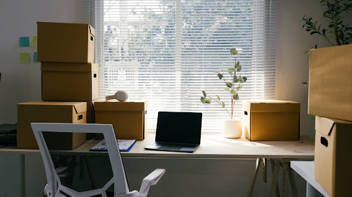 Bunch of boxes and a laptop on a table with a laptop dor side hustle