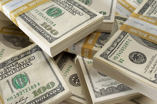 A stack of $100 bills on a table