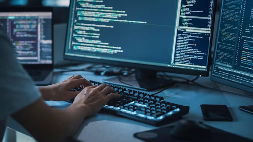 A developer with a laptop displaying codes