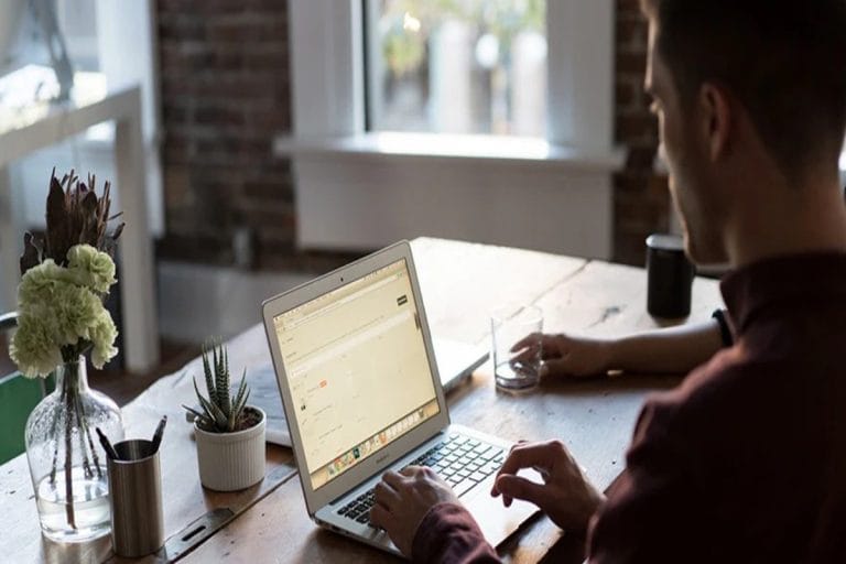 A dropshipping professional checking his sales on his laptop